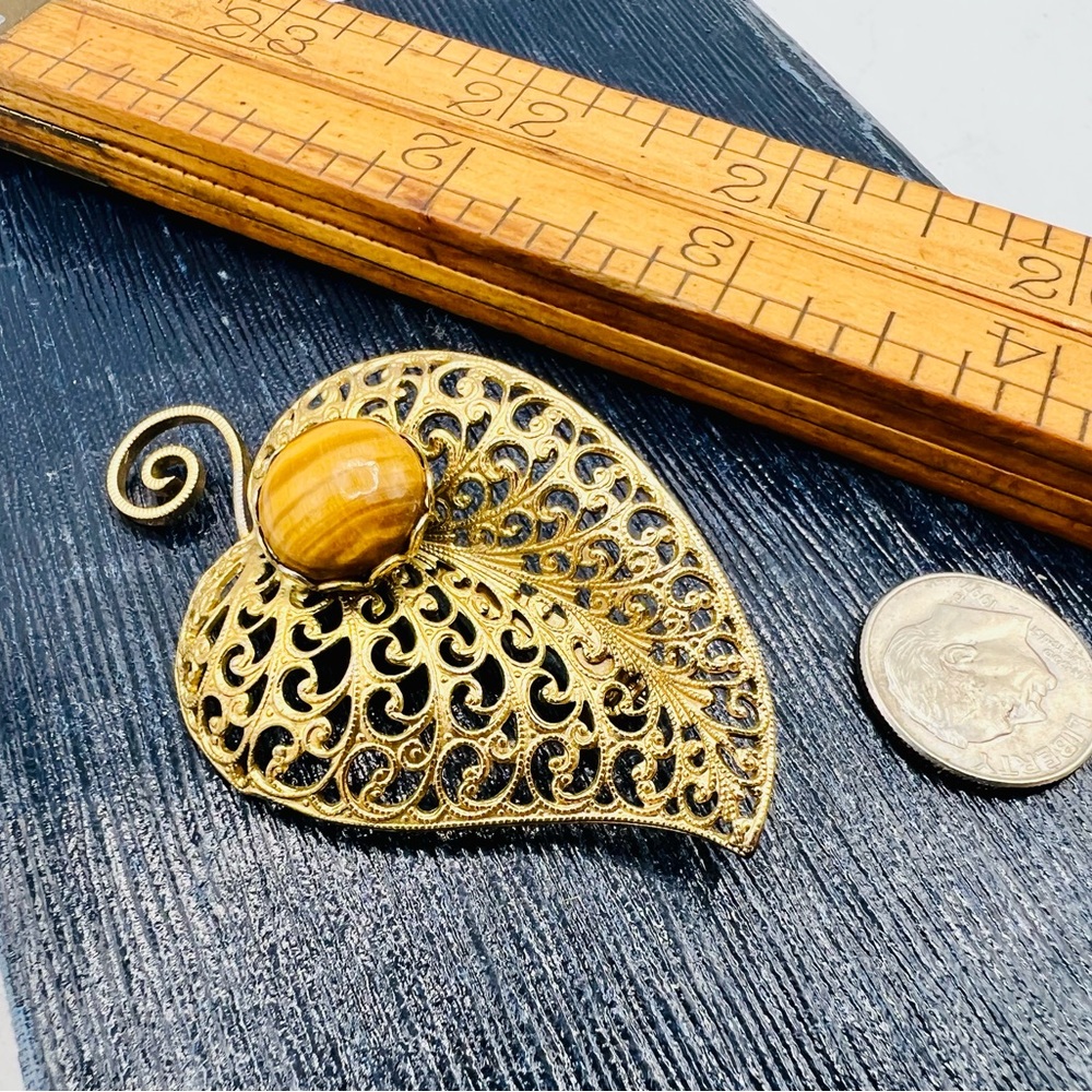 Vintage gold filigree leaf brooch with tigers eye gemstone cabochon